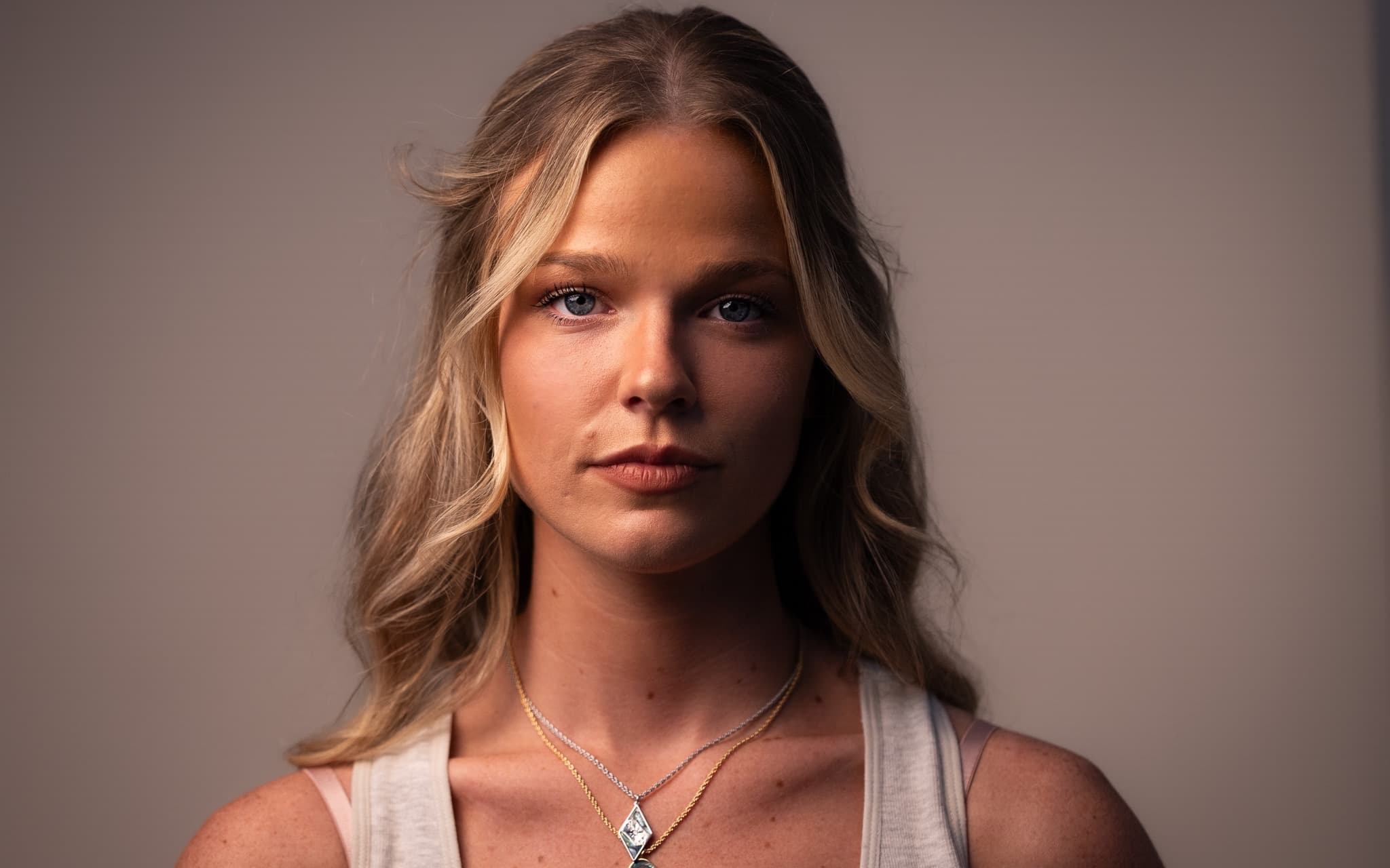 A studio headshot lit on a clean backdrop
